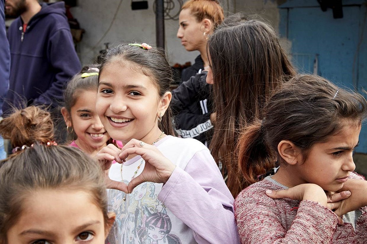 Child forms a Heart with its Hands.